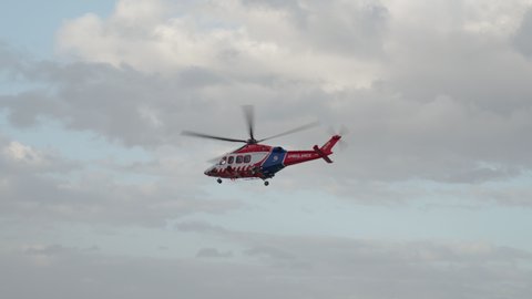 HEMS Helicopter hovering then flying away at Portland Hospital. Portland - Victoria - Australia - May 7, 2020.