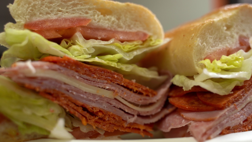a delicious  hero sandwich on the table Royalty-Free Stock Footage #1052635973