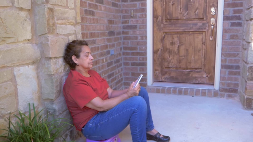 Senior reading on an electronic device comfortably outdoors