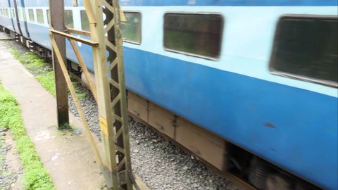 MAHARASHTRA, INDIA - JULY 19, 2019:Passenger Train in Blue which is lifeline of the region in transporting people to location of work,Old Rail Tracks in Lonavala city joining Mumbai and pune motion