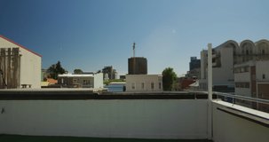 Caucasian man, wearing casual clothes, practicing parkour on a rooftop in a city on a sunny day, running and jumping, in slow motion.  - Powered by Shutterstock - Get 15% off with code: PIKWIZARD15