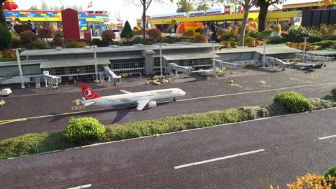 Billund, Denmark, 11/15/2019, Lego land. A day scene at the airport. One Turkish airline plane preparing for take off. People are waking around at amusement park