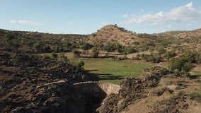 4K aerial drone summer day video of African savanna, Stengel water dam surrounded by bushy hills, Daan Viljoen National Reserve, Khomas Hochland area near Windhoek, Namibia's capital, southern Africa