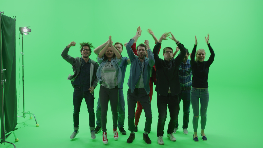 Green Screen Chroma Key Studio: Diverse Crowd of Multi-Ethnic Fans Cheering, Jumping and Applauding with Hands in the Air at the Public Sport Event, Concert, Festival, Party. Back View Full Shot