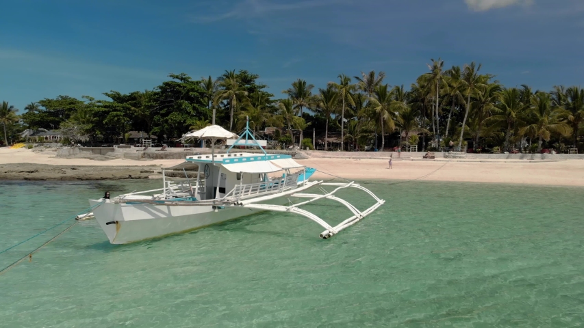 Flying over beautiful beach of tiny Virgin Island, Bantayan, Cebu, Philippines. Aerial view of turquoise tropical lagoon, azure water. Travel. Holidays