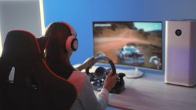 The gamer girl plays a racing video games