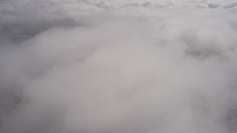 Aerial Hyperlapse above the clouds showing the city of Sao Paulo underneath at sunrise