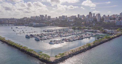 Aerial hyperlapse of boats parked in a marina with the city of Salvador in the background