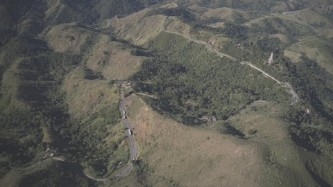 Aerial hyperlapse of the highway in the middle of the mountains by day