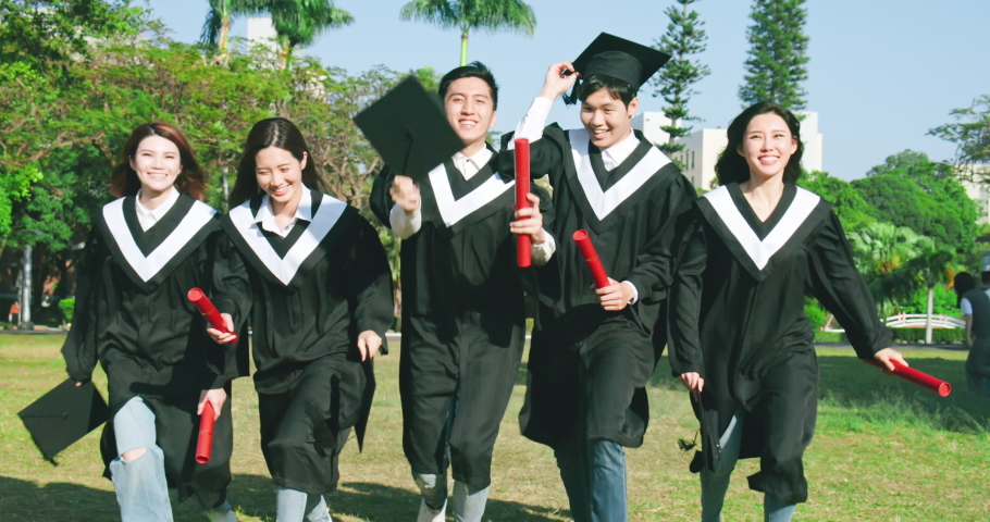 Group happy graduates students run forward and throw their caps into the air | Shutterstock HD Video #1052667230