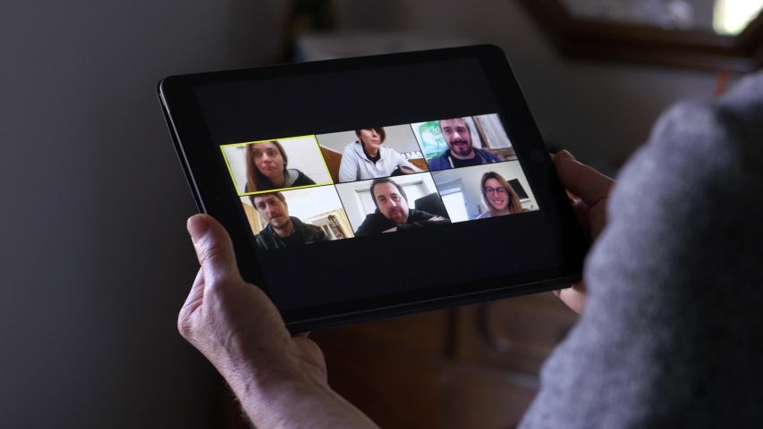 Mature woman in video call on tablet with her son's friends | Shutterstock HD Video #1052667701