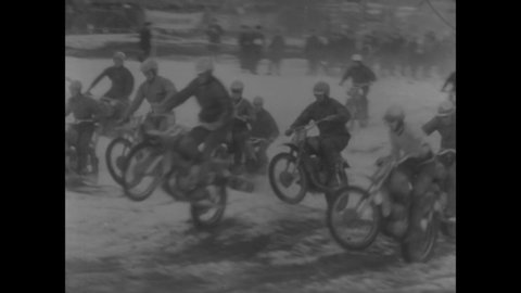CIRCA 1967 - Men ride motorcycles along a snowy, muddy racetrack while competing in the International Winter Motocross Race held in Czechoslovakia.