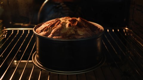 Pie in oven. Timelapse of delicious homemade pie baked. Baking concept. Pie rising up in oven. Close-up shot in 4k, UHD