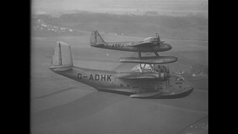 CIRCA 1938 - A Pick-A-Back plane is seen in flight in England.