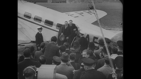 CIRCA 1938 - Large crowds turn out to welcome Prime Minister Chamberlain at the Heston airport after he was at the Munich Agreement.