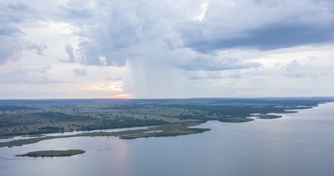 Aerial Hyperlapse of Sunset by the Sucuriu river while white rain cloud getting close