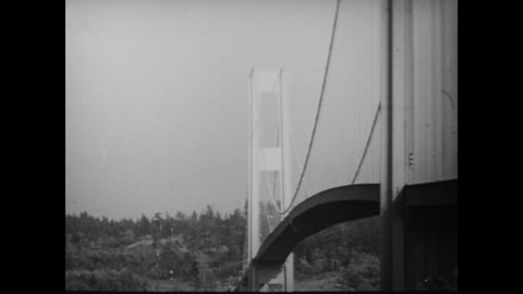 CIRCA 1940 - The Tacoma Narrows Bridge collapses over the Puget Sound in Washington.