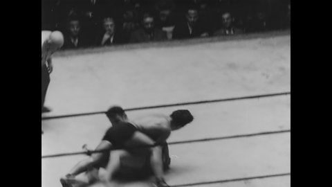 CIRCA 1930 - A professional wrestling match takes place.