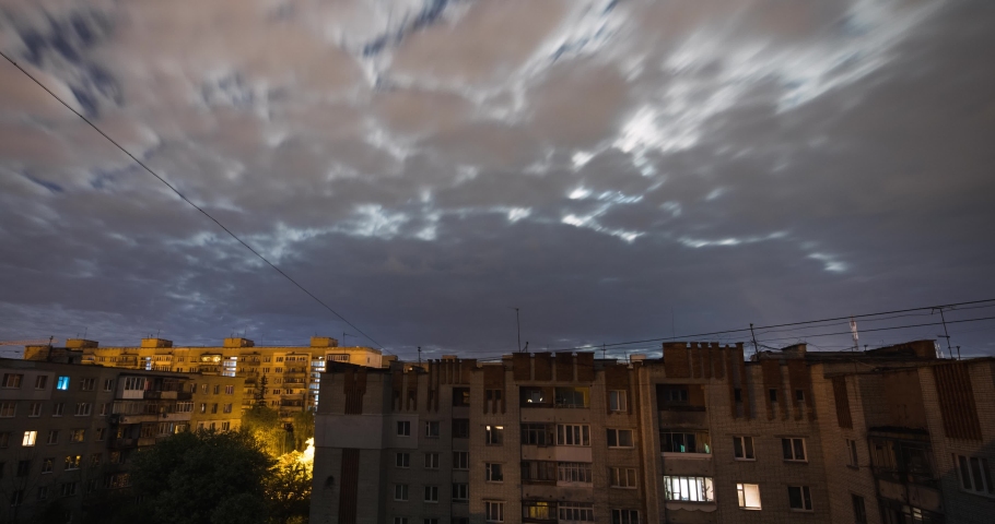 Night time lapse of sky with socialist soviet panel building (plattenbau). The buildings were built in the Soviet Union (now Ukraine). Buildings look like most post-soviet commuter towns.