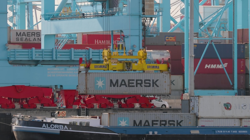 ROTTERDAM, THE NETHERLANDS - SEPTEMBER 18, 2019: Containers loaded onto a ship on automated cranes in the APM Terminals Rotterdam, busiest port of Europe. | Shutterstock HD Video #1052680691