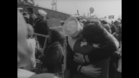 CIRCA 1967 - US Navy sailors on the USS Coral Sea return home from Vietnam, and are reunited with their families on a dock.