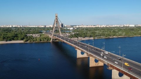 Aerial drone view View Of North or Moscow Bridge Kiev, Ukraine over Dnieper. There is heavy traffic on the bridge.