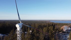 Video of the overflight on the drone of the wind turbines having three blades, painted in different colors quiet calm bright spring day.
