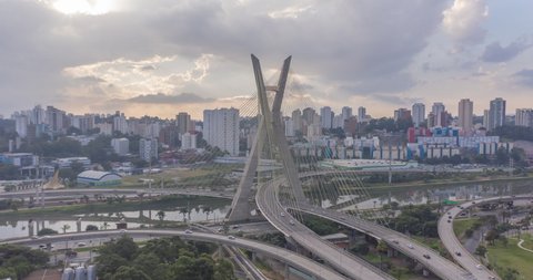 Aerial hyperlapse of the Estaiada bridge in the late afternoon with cars and clouds in the background