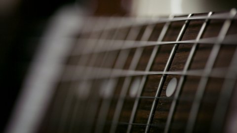 Playing the guitar. Strumming electric guitar. A musician plays music. Shot on RED camera in 4k.
