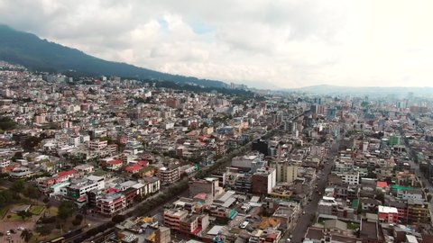 Quito - Ecuador 02-02-2020: Aerial view of Quito, a city with lots of hills on a cloudy day
