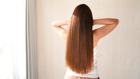 Beautiful brunette girl. Scratch healthy long hair.