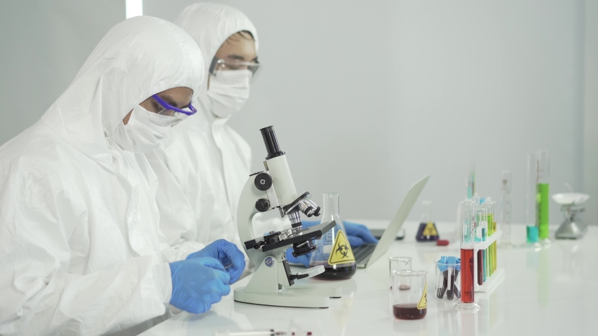 Asian scientist doing some research and looking through a microscope in laboratory. Healthcare Videos Asian scientist doing some... 