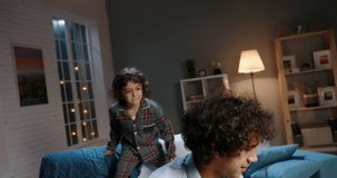 Young asian father playing with his little son. Funny kid with curly hair doing a piggy back ride, having fun at home - happy family, recreational pursuit concept 4k footage