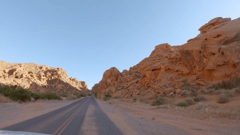 Point of view of vehicle driving on empty road in Valley of fire state park. Car mounted camera, views of stunning rock formation. Road trip travel concept. Freedom on the road 