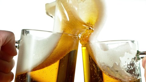 Super slow motion of two beer glasses hitting together, cheers concept. Filmed on high speed cinema camera, 1000 fps.