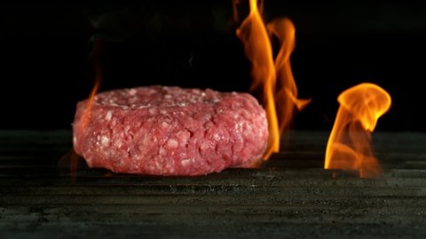 Super slow motion of falling hamburger steak on grill. Filmed on high speed cinema camera, 1000 fps.