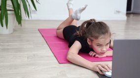girl teenager sports home. gymnastics online. dancing on the quarantine. stretching on a gym Mat.