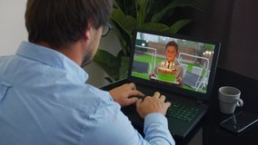 Happy birthday to a businessman over the internet. Cake with candles shown in webcam. Home quarantine, social distancing, self isolation.