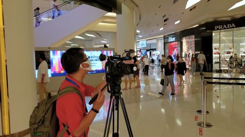 Journalist Filming Footage of Customers Wearing Face Masks For News Report on Newly Re-Opened Shopping Malls in Bangkok, Thailand - May 17, 2020