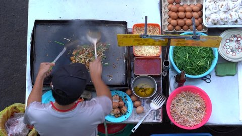 Kota Kinabalu, Malaysia - february 24, 2020 : Man cooking Chinese traditional appetizer is the Chai Taw Kway or Kuih Lobak Goreng in Malay and fried radish cake in English, street market