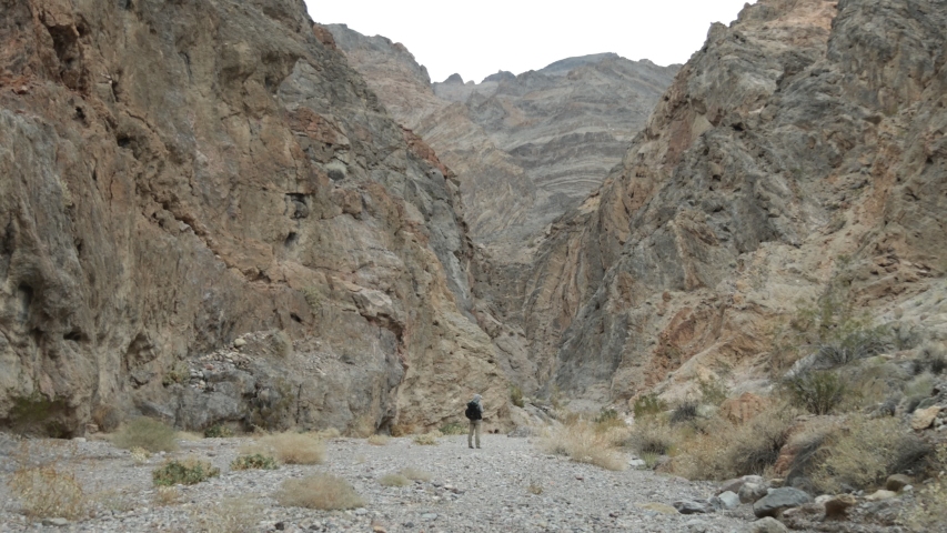 Two male hikers walk through Fall Canyon in Death Valley National Park in California.