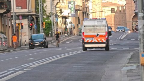 Bologna, Italy - May 9, 2020: Italian ambulance on emergency call on the road with siren, during Covid-19 time and measures of lockdown in Bologna town in May 2020. Departing from Maggiore hospital.