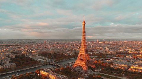 
Aerial drone distant sunset view of Tour Eiffel Tower and Seine River bridge traffic cars driving, Paris city attractions, France 