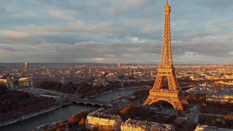 
Aerial drone distant sunset view of Tour Eiffel Tower and Seine River bridge traffic cars driving, Paris city attractions, France 