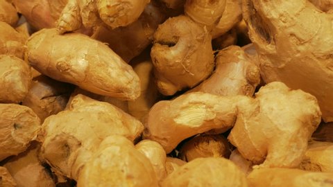 A lot of ginger root on a counter in a store