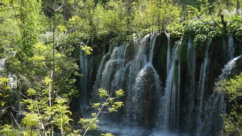Large waterfall in the Plitvice Lakes National Park in Croatia. The Korana River, caused travertine barriers to form natural dams, which created a number of picturesque lakes, waterfalls and caves.