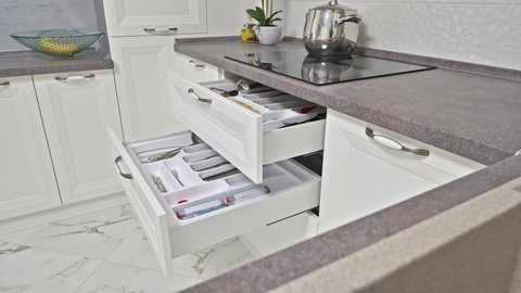 Zoom to open drawers of well designed modern wooden white kitchen