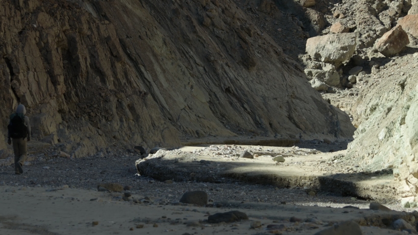 A male hiker walks down the Gower Gulch trail in Death Valley National Park, California.