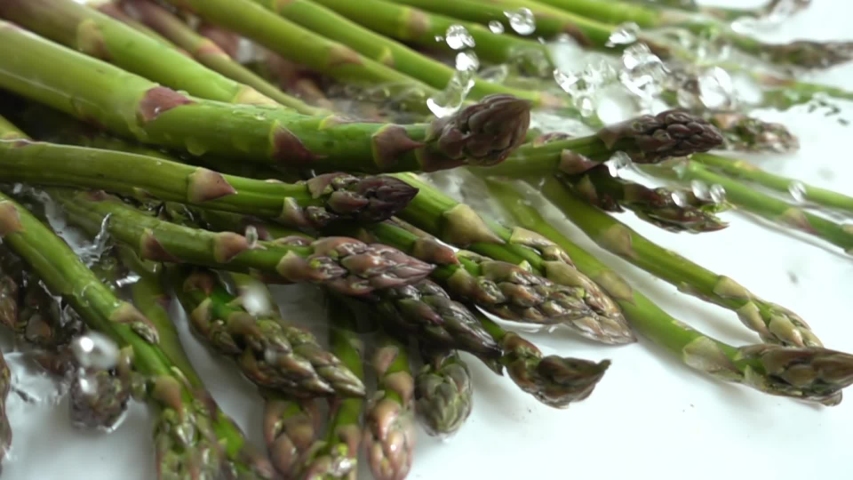 Fresh green asparagus. Water splashes. Slow motion. - Powered by Shutterstock - Get 15% off with code: PIKWIZARD15
