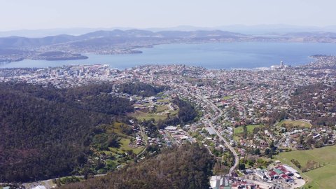 High aerial of Hobart city scape, CBD, ports and harbour, Derwent River, looking east